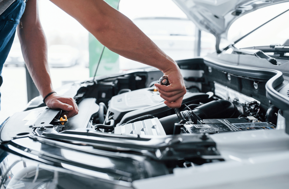 Man working with engine under the hood