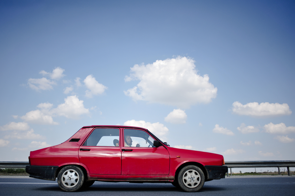 older model Dacia car on the highway