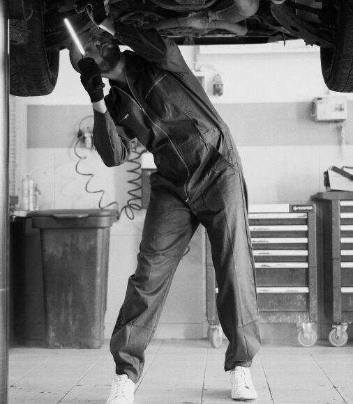 man checking a car from underneath