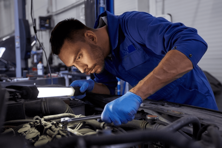 Edmonton diesel mechanic working on an engine
