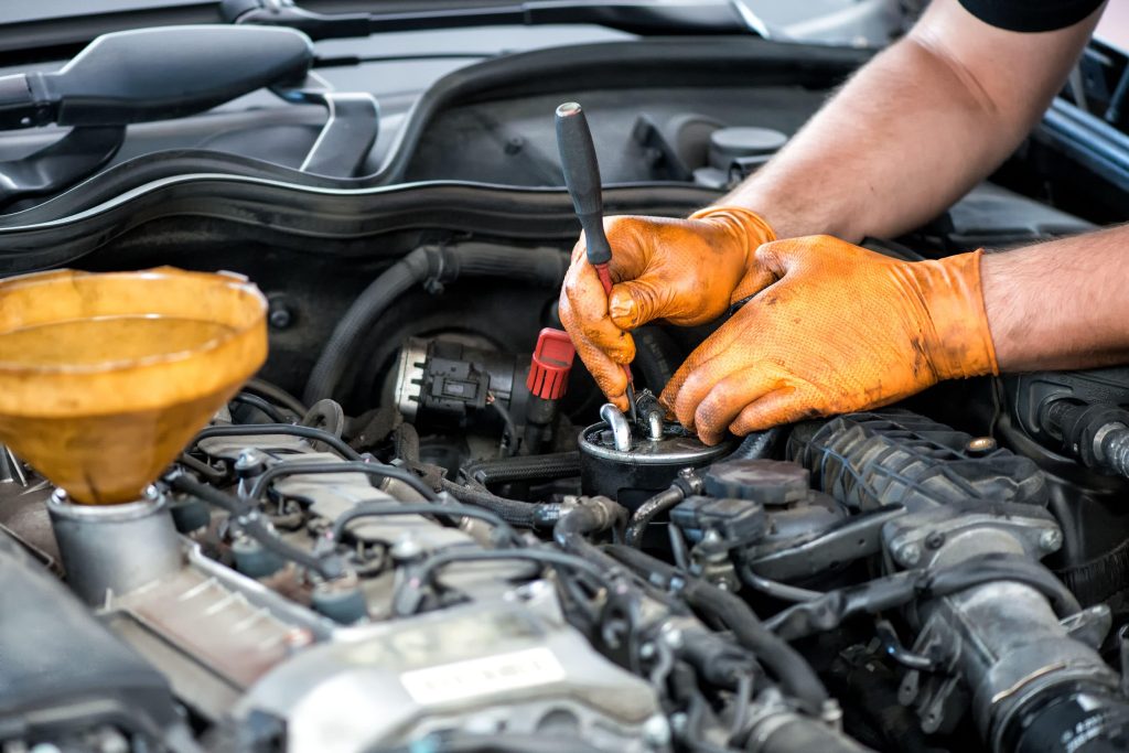 Edmonton diesel mechanic working on a diesel filter