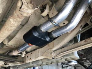 Flowmaster Super 19 muffler installed on dual exhaust pipes under a vehicle