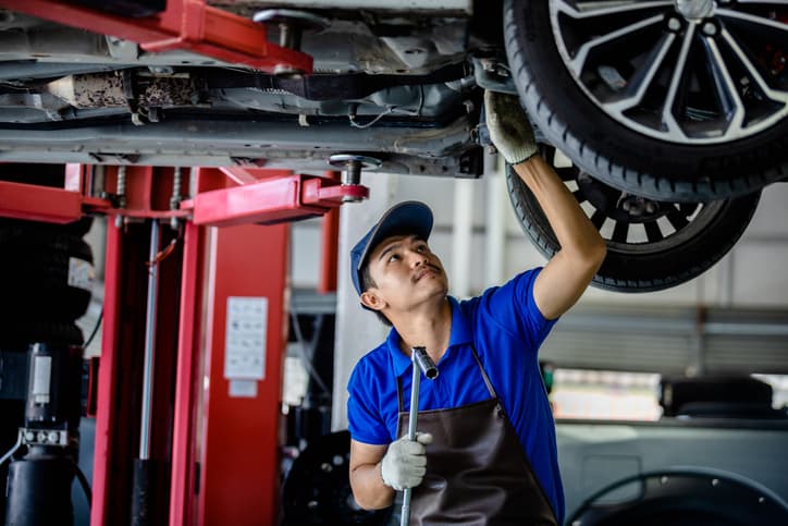 auto-mechanic-inspecting-vehicle-lift