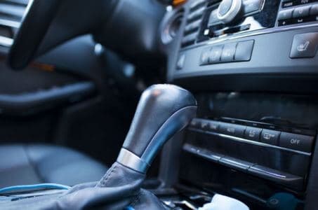 Close-up of an automatic car gear shifter and center console interior